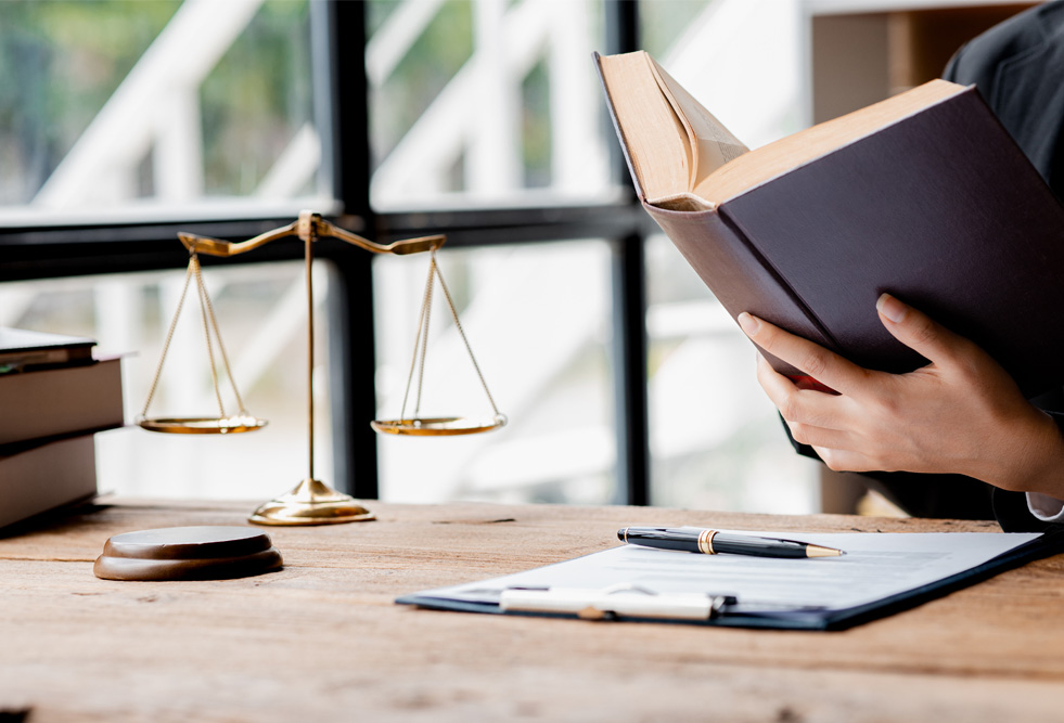 Judge gavel and scales of justice and book background