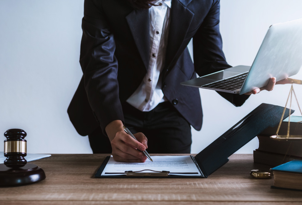 Judge gavel and scales of justice and book background